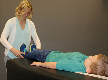 Chiropractor Waukee IA Kelsey Pettitt Activator Method On Child