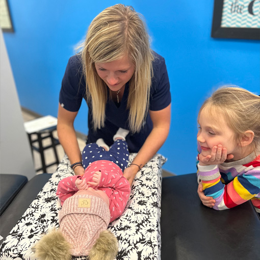 Chiropractor Waukee IA Kelsey Pettitt Adjusting Baby
