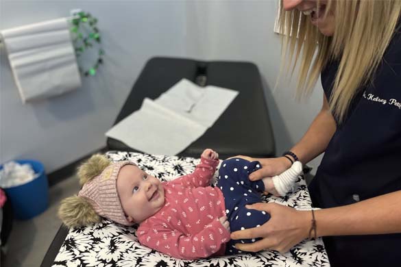 Chiropractor Waukee IA Kelsey Pettitt With Infant Patient