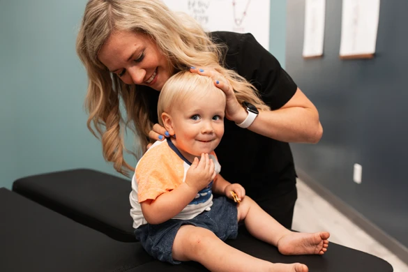 Chiropractor Waukee IA Kelsey Pettitt Adjusting A Baby Dr. Kelsey Pettitt adjusting a baby.