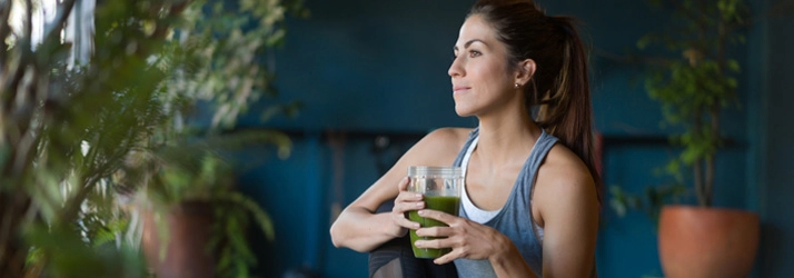 Chiropractic Waukee IA Fitness Woman Woman sitting with a smoothie.