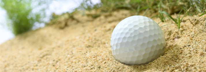 Chiropractic Waukee IA Golf Ball Sand Trap A golf ball in stuck in a sand trap.