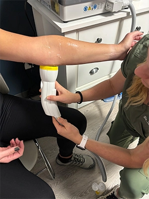Chiropractic Waukee IA SoftWave Therapy SoftWave therapy on a patients elbow.