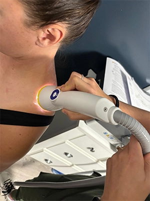 Chiropractic Waukee IA SoftWave SoftWave therapy on a patients shoulder.