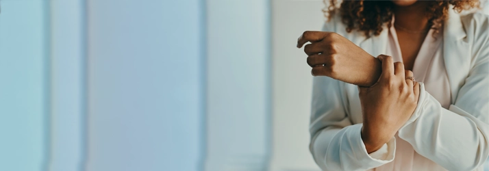 A person holding their wrist in pain.